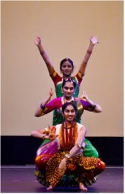 Three teenage girls performing a native Indian dance.