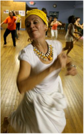 Senior citizen woman dancing in an African Dance class